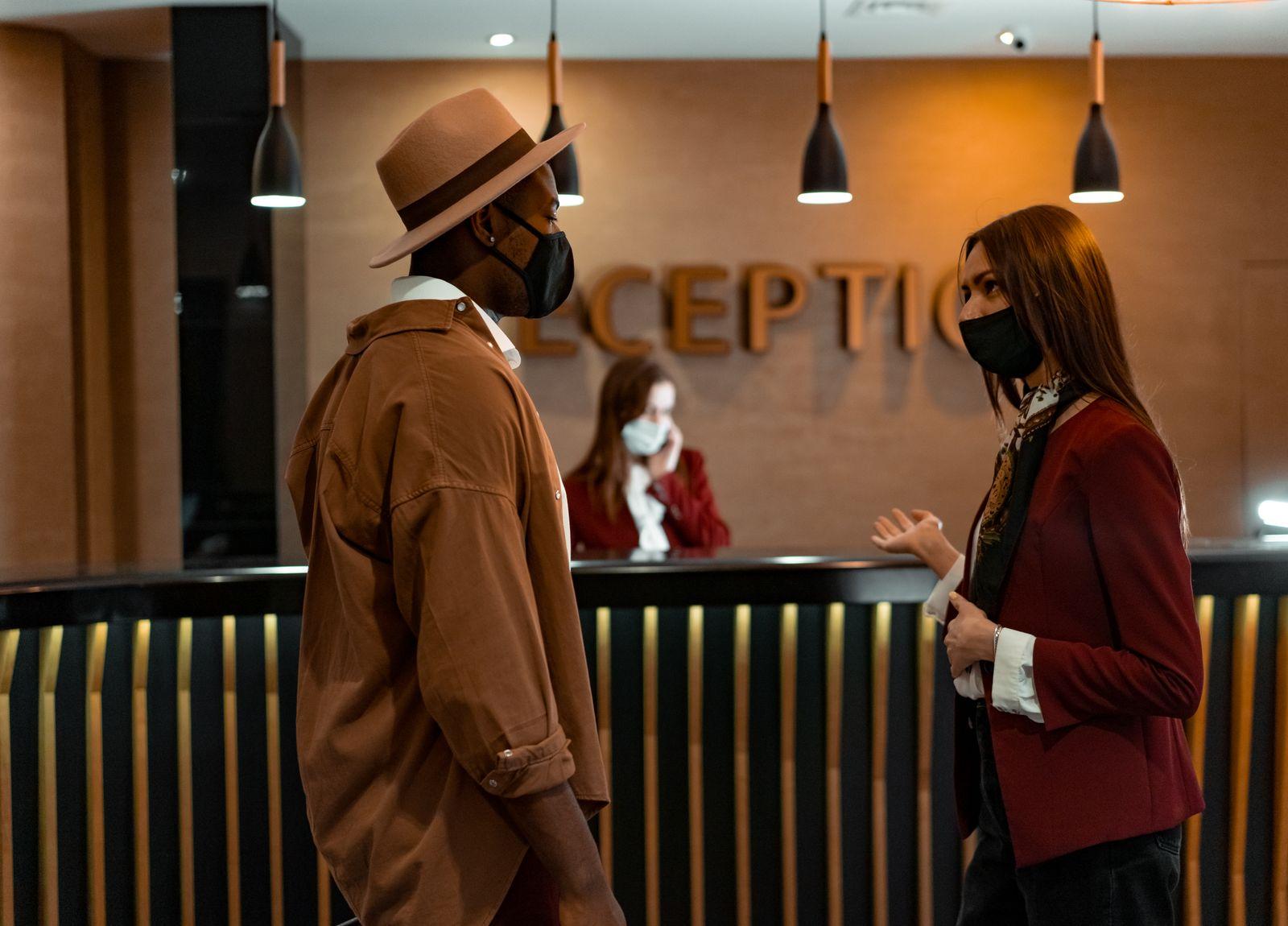 Guests checking in at a hotel reception