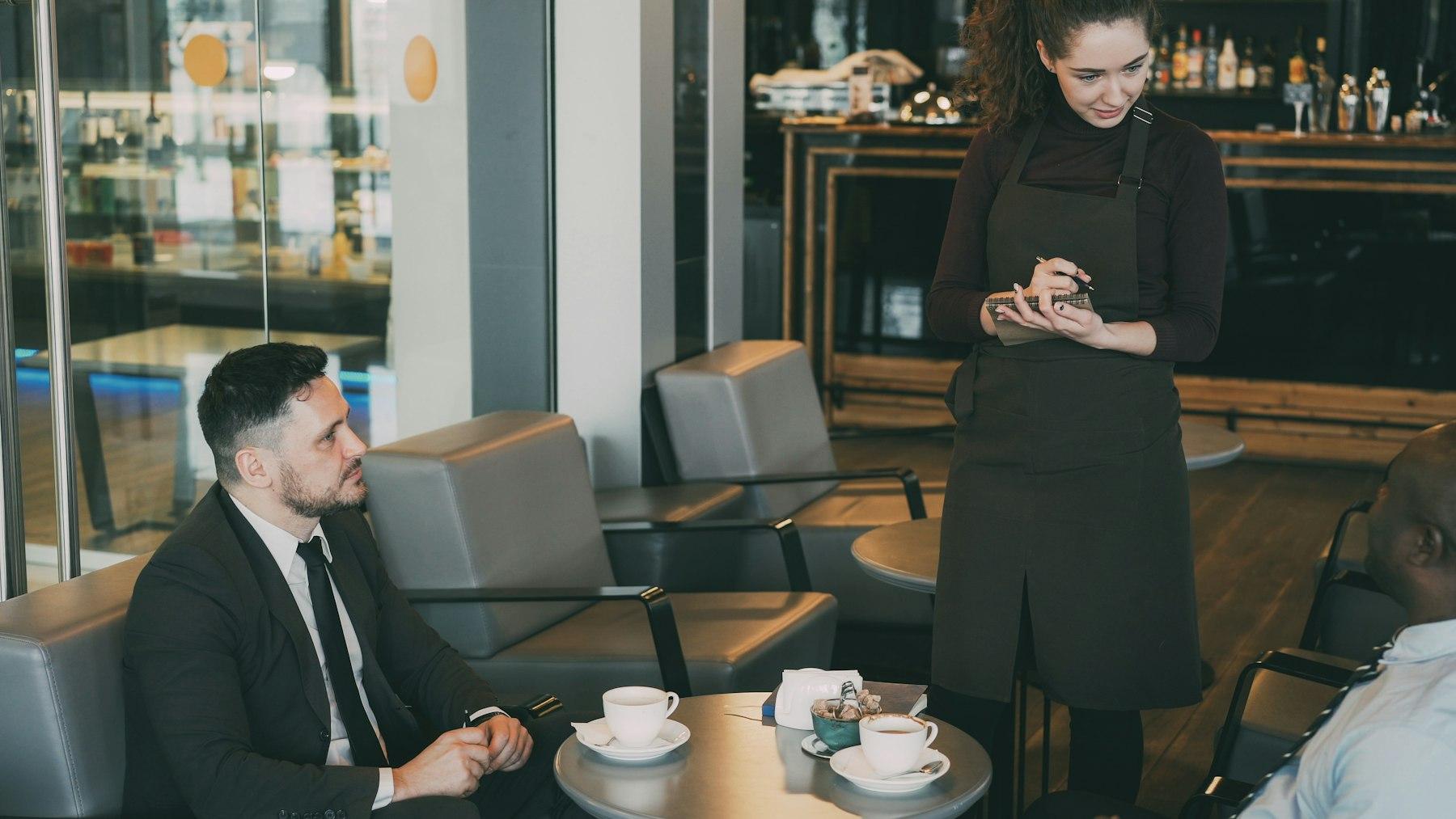 A business traveller ordering at a café