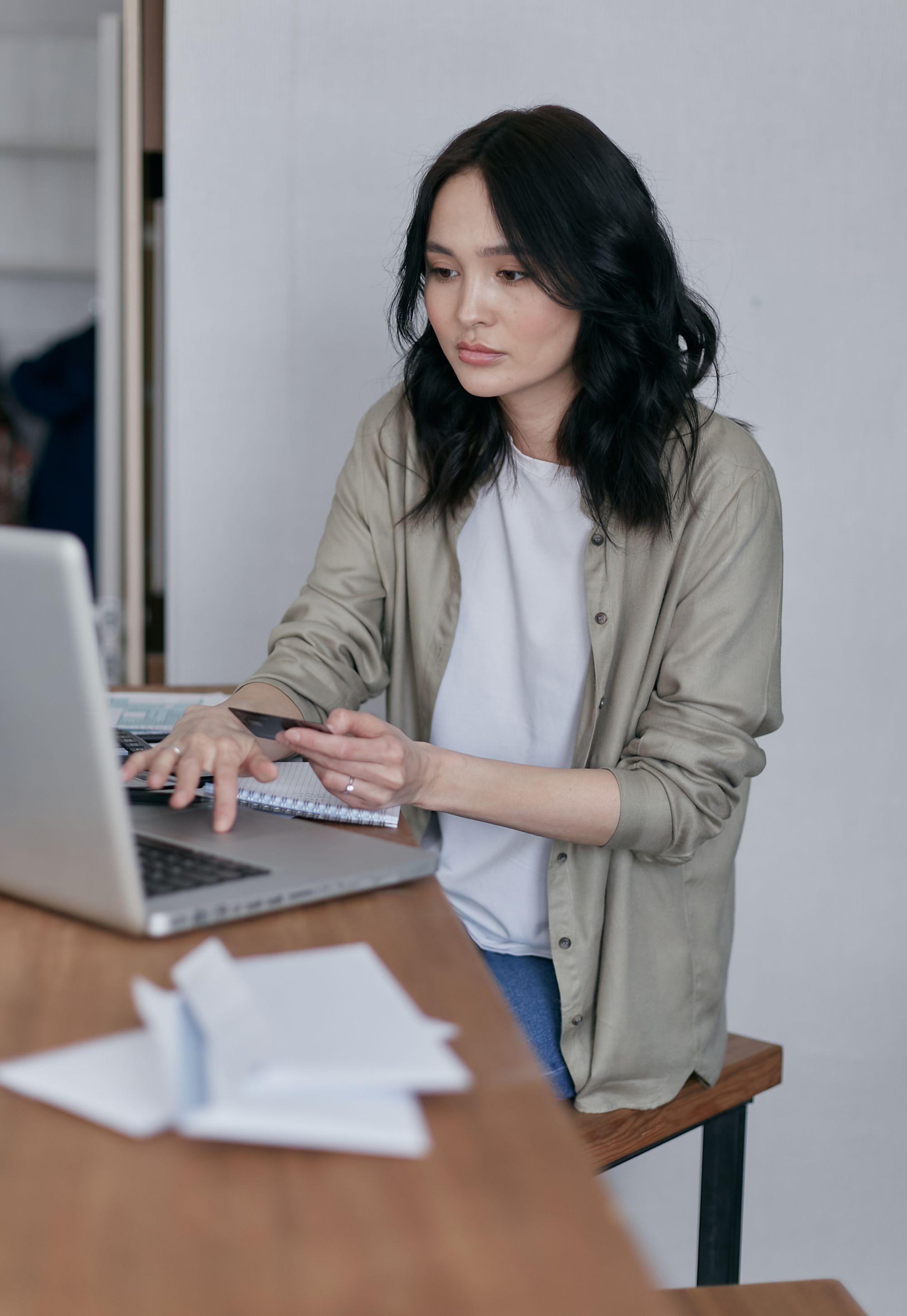 A woman typing on her laptop