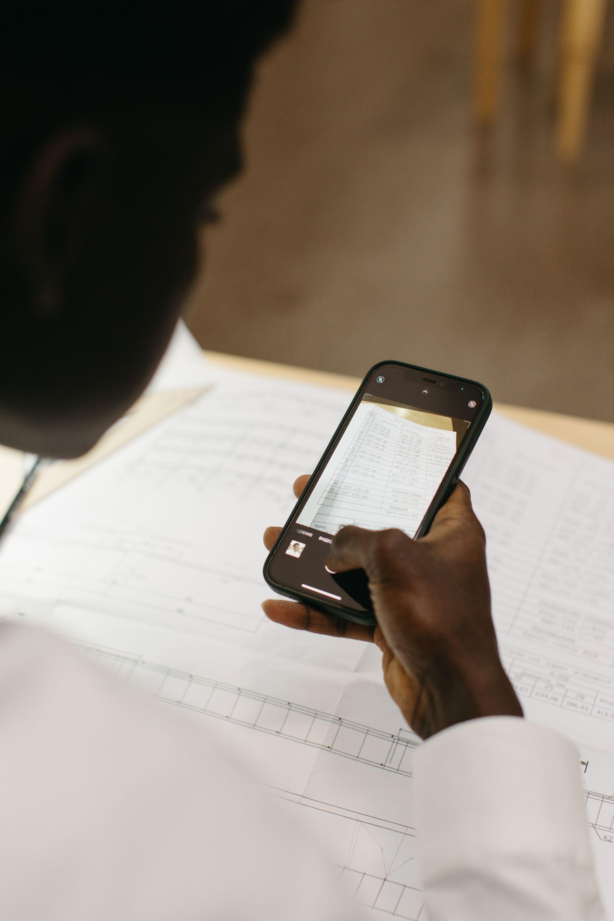 A man photographing a document with his phone