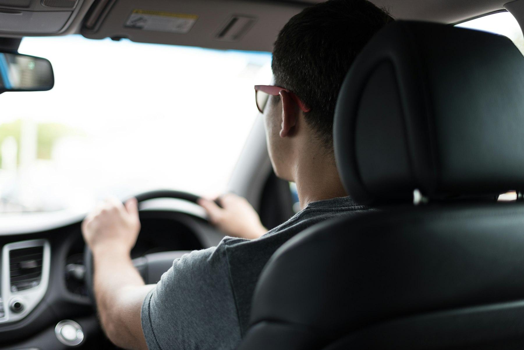 A man driving on a business trip