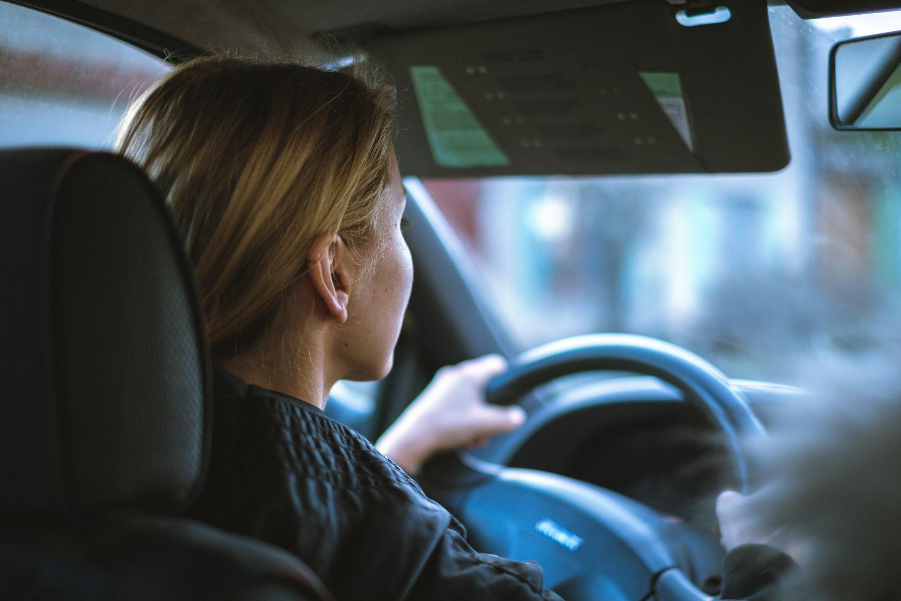 A woman driving to a client meeting
