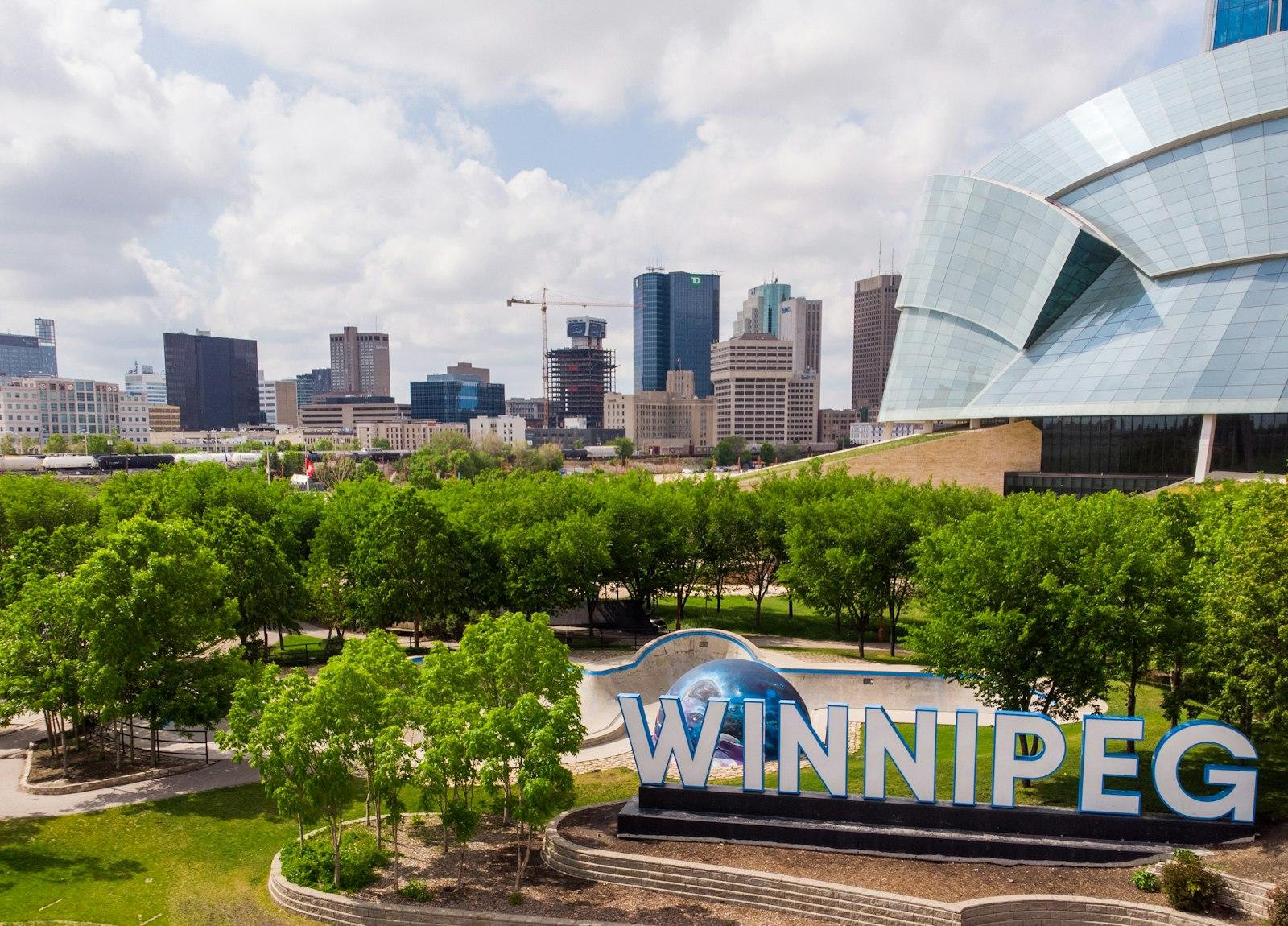 The Winnipeg sign at The Forks, with the Canadian Museum for Human Rights behind it