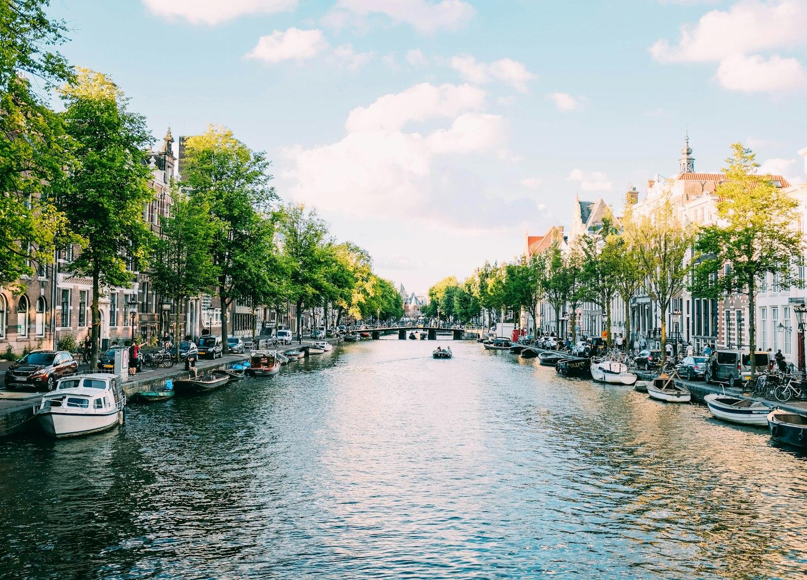 Boats moored along a canal in Amsterdam